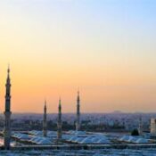 Stunning view of the Prophet's Mosque minarets at sunset in Medina, Saudi Arabia.