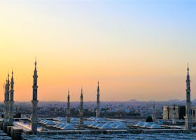 Stunning view of the Prophet's Mosque minarets at sunset in Medina, Saudi Arabia.